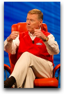 Ford CEO imitating the woman driving with her hands through the wheel