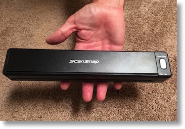 Steve holding the iX100 scanner with the tips of his fingers