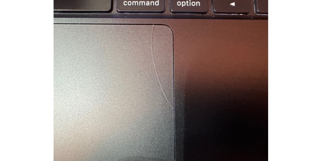 crack in the upper right of my trackpad - looks like a hair