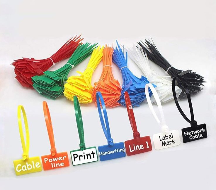 A picture of bundles of plastic "zip tie" cable ties in red, green, yellow, orange, blue, white, and black. In front of the bundles is one of each colour looped into itself to show how they hold cables. The looped ones each have a written label on the large plastic tag.