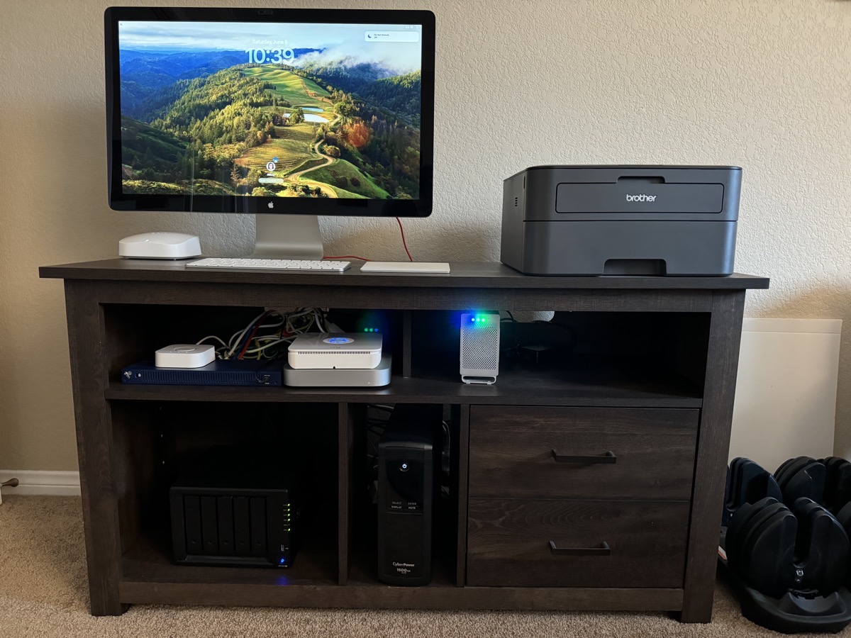 Brother black and white laser printer HL-L2360D next to Mac mini and 27 inch Cinema Display and Synology.