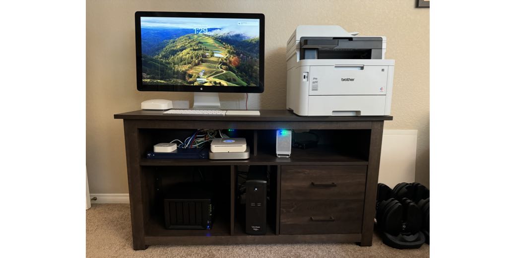 Brother color laser printer L3780 next to Mac mini and 27 inch cinema display and Synology