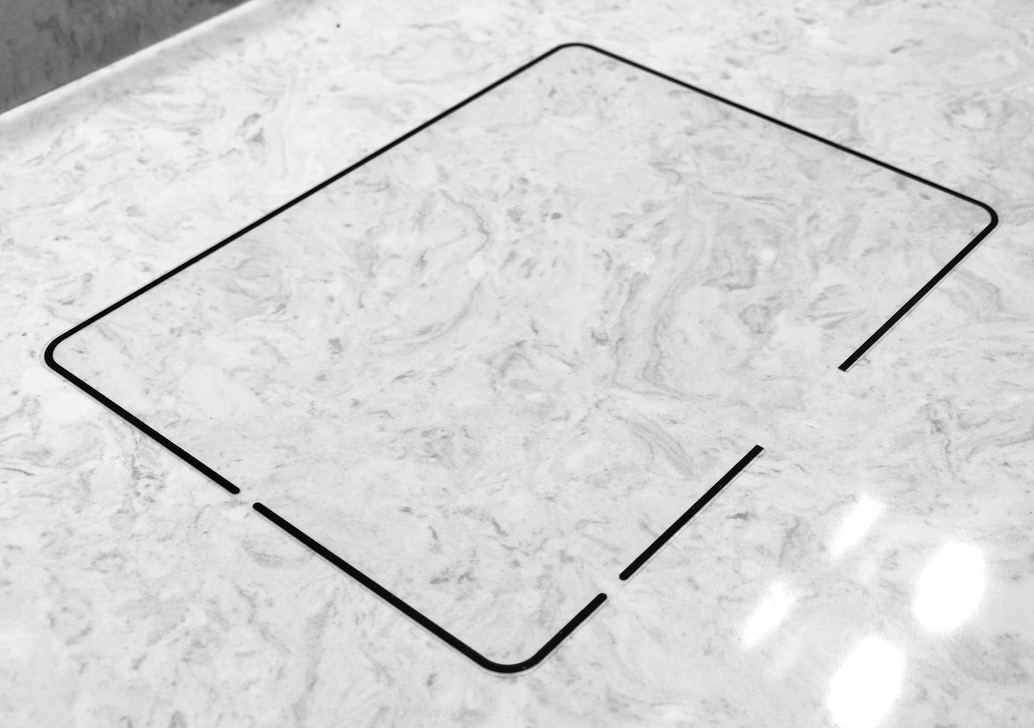 Rock Paper Pencil screen protector on marble counter.