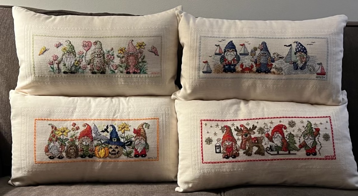 All four gnome cross stitch pillows. There's Spring, Summer, Halloween, and Christamas