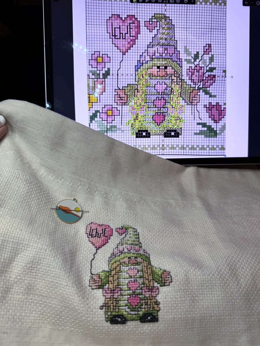 Spring gnome stitching in foreground with Notability showing outlining in background.